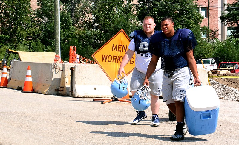 Westminster College students Chandler Becker and Christopher Goodwin Jr. walk across Seventh Street on their way to football practice on Monday afternoon. The street, which had been closed for construction to the Seventh Street bridge, reopened on Friday, Aug. 15 - just in time for classes.