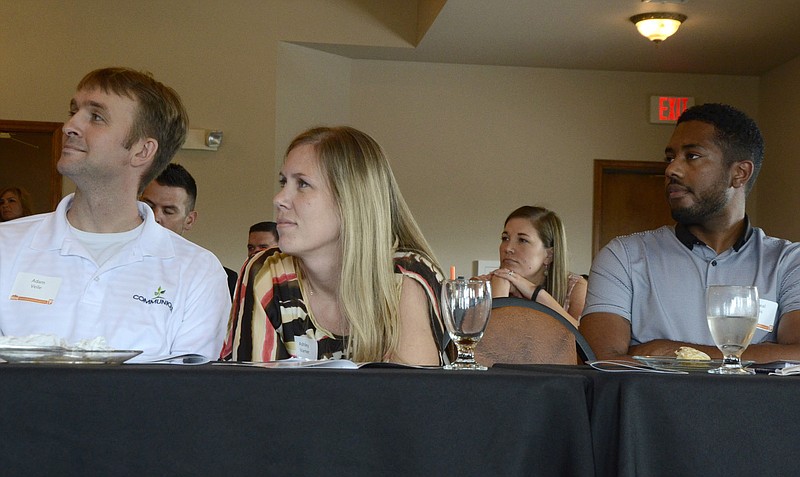 From left, Adam Veile, 34, of Comminique; Ashley Varner, 33, of Central Missouri Community Action; and Michael Lewis, 28, of Columbia College, listen to a presentation during the 2014 Missouri Young Professional Summit.