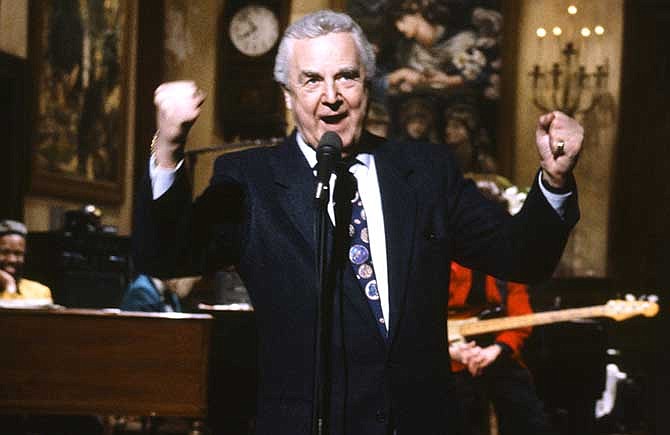 This March 14, 1992 photo provided by NBC shows announcer Don Pardo on the set of "Saturday Night Live." Pardo, the durable television and radio announcer whose resonant voice-over style was widely imitated and became the standard in the field, died Monday, Aug. 18, 2014 in Arizona at the age of 96.