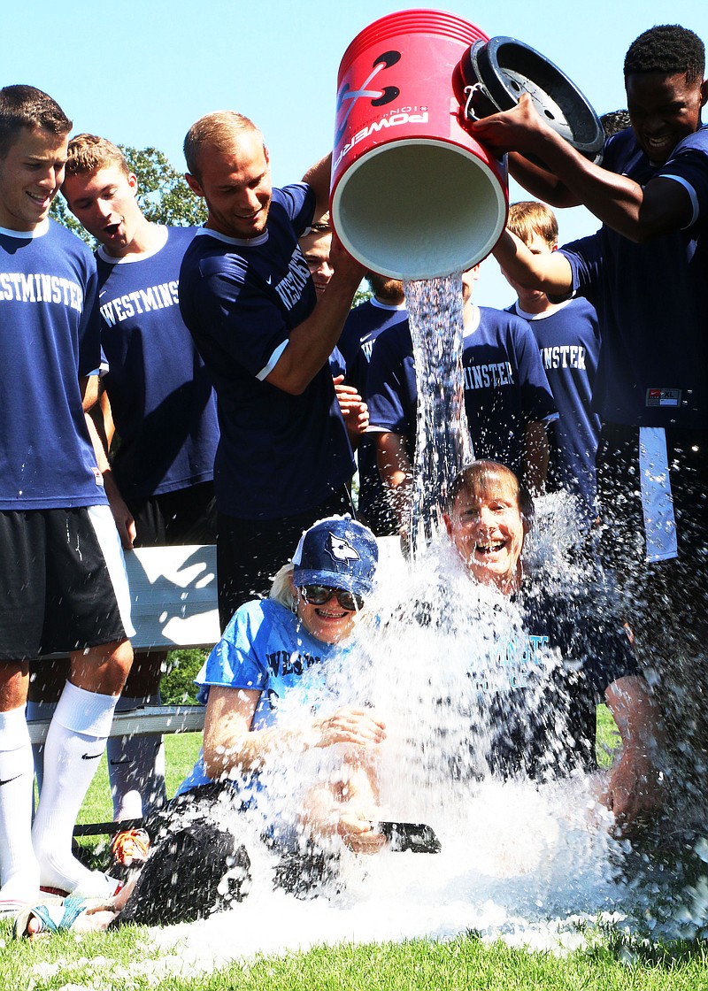 Westminster College President  George B. "Barney" Forsythe and his wife Jane sit on the school's soccer field as the men's soccer team dumps ice water over their heads. The two did as part of the ice bucket challenge. 