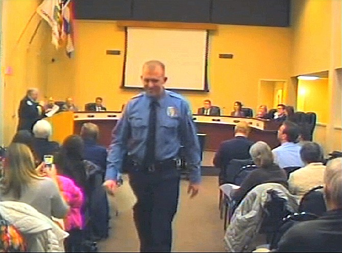 In this  Feb. 11, 2014, image from video released by the City of Ferguson, officer Darren Wilson attends a city council meeting in Ferguson. Police have identified Wilson as the police officer who shot Michael Brown on Aug. 9, 2014, sparking protests in the suburban St. Louis town. 