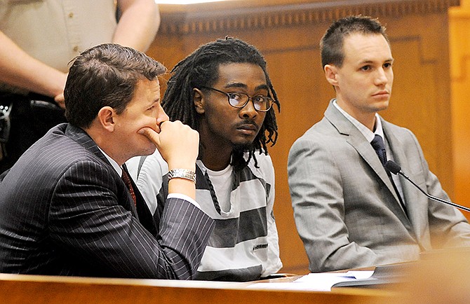 Domionte S. Cheatum, 21, center, looks at people in the courtroom today prior to his sentencing with his public defenders Derek Roe, left, and Jeremy Pilkington. Cheatum was sentenced by Circuit Judge Christine Carpenter to 40 years in prison for the shooting death of Anthony Unger, 25, June 23, 2013 in the parking lot of the Broadway Marketplace Center on Conley Road in Columbia during a drug deal.