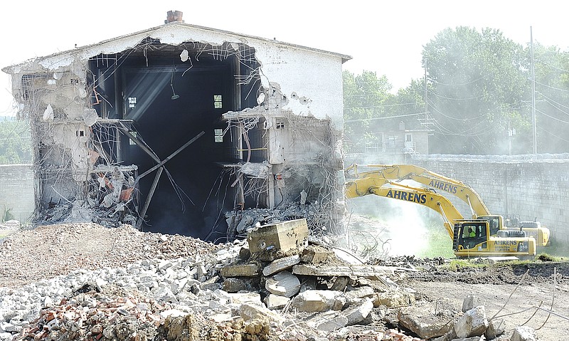 Dust flies in the air as demolition of I-Hall on the grounds of the old Missouri State Penitentiary continues. Funds for the work wwere provided through a state community development block grant awarded to the city in 2010.