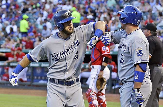 Kansas City Royals Alex Gordon (4) celebrates his solo home run with teammate Billy Butler during the first inning of a baseball game against the Texas Rangers, Saturday, Aug. 23, 2014, in Arlington, Texas.