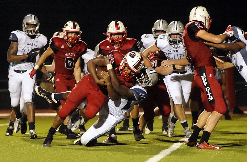 Jefferson City running back Elijah Pittman keeps his eyes on the goal line as he bowls over McCluer North's Robert Pattin to put the Jays on the board in the second quarter of Friday night's game at Adkins Stadium.