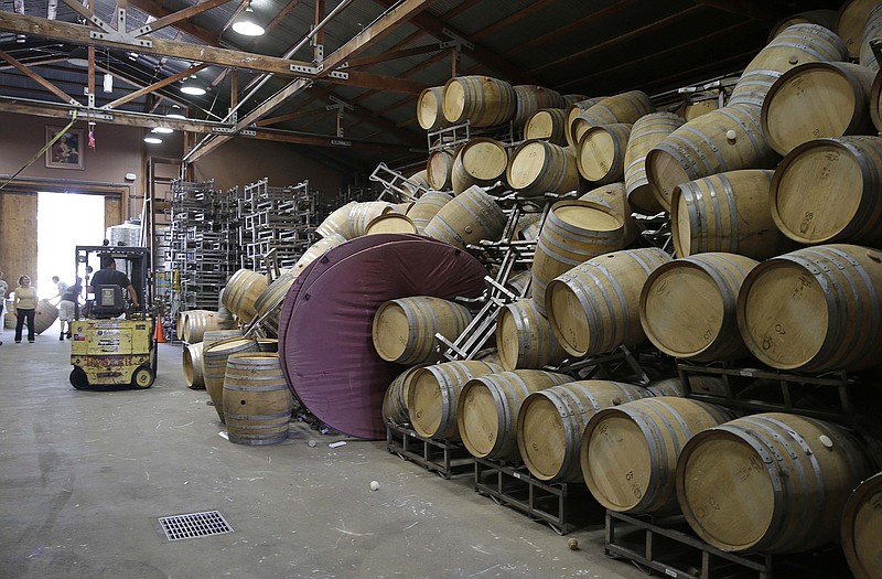 Cellar workers continue cleanup after a number of barrels toppled following an earthquake at the Saintsbury winery Sunday in Napa, Calif.  Winemakers in California's storied Napa Valley woke up to thousands of broken bottles, barrels and gallons of ruined wine as a result of Sunday's earthquake. 