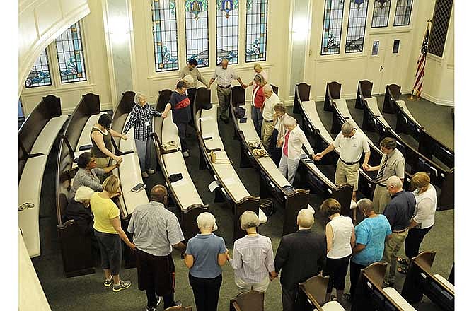 The First Presbyterian Church in Jefferson City hosted a noon service Friday to pray for peace and reconciliation both in Ferguson and around the world. Nearly two dozen were in attendance for the service, which lasted
more than an hour and featured prayers and hymns. At the conclusion of the service, everyone stood
and held hands while they prayed.