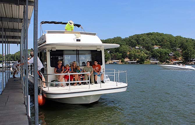 Families aboard "The Dog House" houseboat enjoy the Lake of the Ozarks Shootout Make-a-Wish rides on Thursday.
