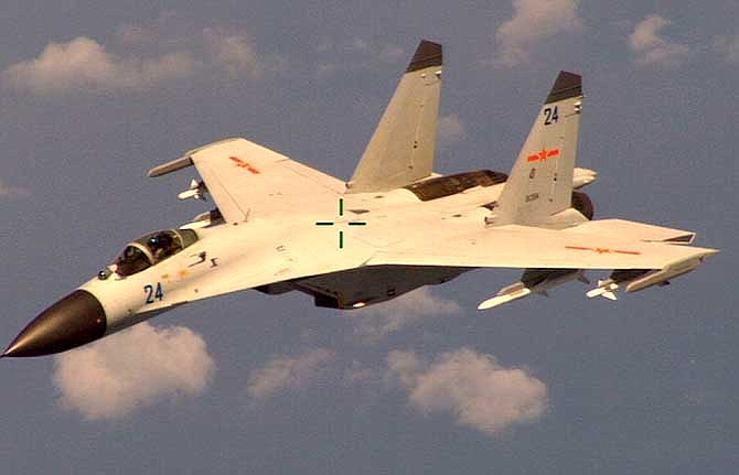 This handout photo provided by the Office of the Defense Secretary (OSD), taken Aug. 19, 2014, shows a Chinese fighter jet that the Obama administration said Friday conducted a "dangerous intercept" of a U.S. Navy surveillance and reconnaissance aircraft off the coast of China in international airspace. 