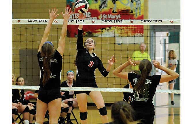 Jefferson City setter Jenna Massie fires a shot into the St. Joseph's Academy defense in the second game of Saturday's match at Fleming Fieldhouse.