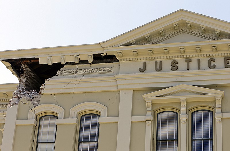 An upper corner of the Napa County Courthouse displays structural damage after an earthquake on Sundain Napa, Calif. 