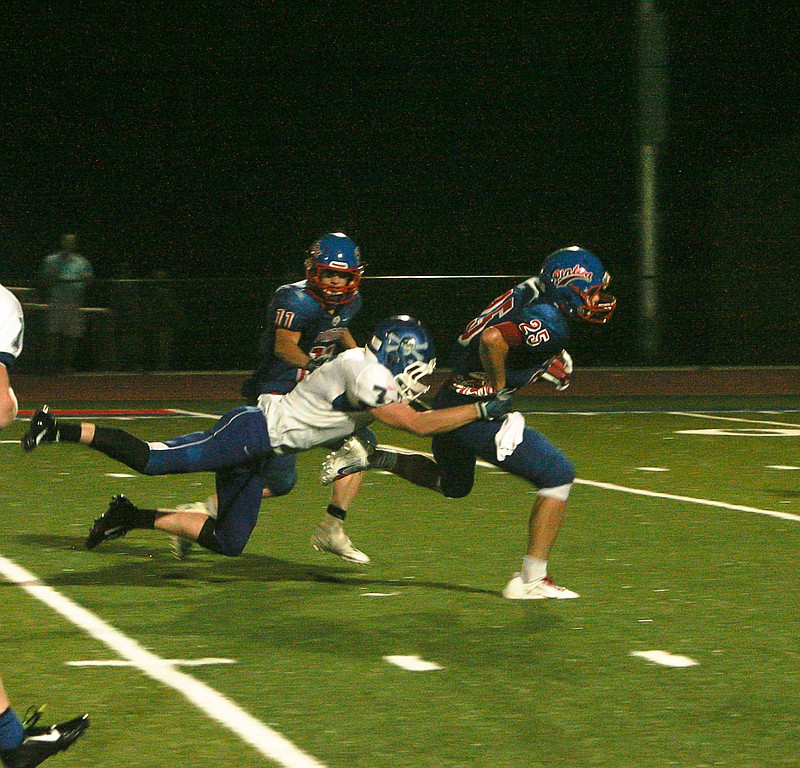 Democrat photo / April Arnett
California's Drew Norton (25) breaks free from Boonville's Alec Viertel (7) with help from teammate Walker Borghardt (11) during the second quarter of Friday's varsity game at Riley Field. 