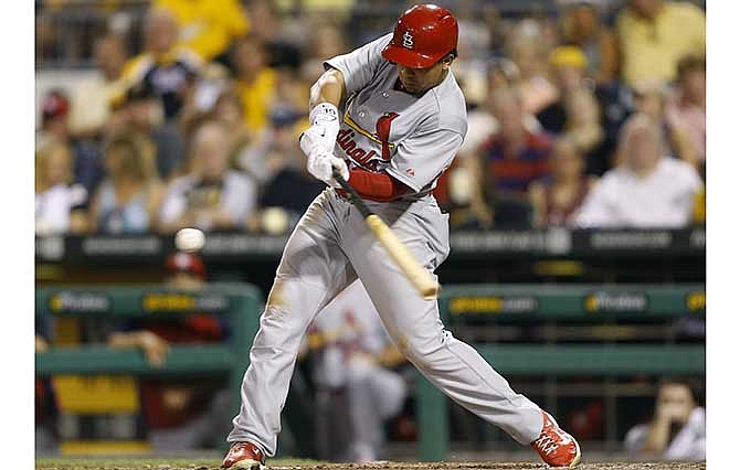 St. Louis Cardinals' Jon Jay hits a sacrifice fly to drive in Matt Adams with the of the baseball game against the Pittsburgh Pirateson Tuesday, Aug. 26, 2014, in Pittsburgh. 