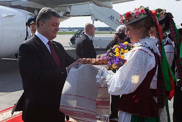 Ukrainian President Petro Poroshenko gets traditional salt and bread upon arrival in Minsk, Belarus on Tuesday. Poroshenko arrived in Minsk for discussions with Russia and Ukraine with a view to creating a new political impulse towards finding a political, sustainable solution to the situation in Ukraine.
