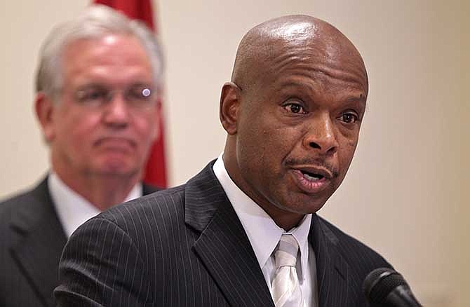 Former St. Louis Police Chief Dan Isom, left, speaks after he is named the director of the Missouri Department of Public Safety during a news conference with Gov. Jay Nixon, left, on Wednesday, Aug. 27, 2014, in St. Louis. Nixon appointed Isom nearly three weeks after the police shooting of Michael Brown led to violent protests in a St. Louis suburb. Nixon did not directly say whether the leadership change was related to the events in Ferguson. (AP Photo/St. Louis Post-Dispatch, Huy Mach)