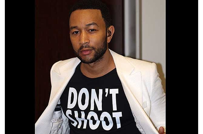This Aug. 20, 2014 photo released by singer John Legend shows Legend wearing a T-Shirt that says "Don't Shoot," in reference to the Aug. 9 shooting of Michael Brown in Ferguson, Mo., at the Hollywood Bowl in Los Angeles. Legend performed Marvin Gaye's What's Going on with the Los Angeles Philharmonic. 