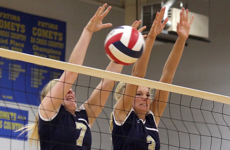 Helias teammates Lindsey Griggs (7) and Erica Haslag (3)  jump into the air to block a shot during Thursday night's match against Fatima in Westphalia.