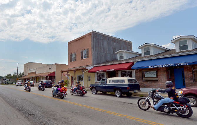 A group of motorcyclists rolled south on Main Street in Grain Valley, Mo., Thursday, Aug. 28, 2014. The Bandidos Motorcycle Club is holding a Labor Day weekend event in Grain Valley that is expected to draw a crowd of 1,500 to 2,000 people according to the Missouri Highway Patrol, which is part of the increased law enforcement presence in town.