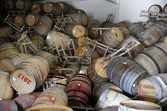 This Aug. 24, 2014 file photo shows barrels filled with Cabernet Sauvignon that toppled on one another following an earthquake at the B.R. Cohn Winery barrel storage facility in Napa, Calif. Napa Valley's seismically reinforced winery buildings generally held up to the largest earthquake to hit Northern California in a quarter-century, but the precious wine piled inside often did not. 