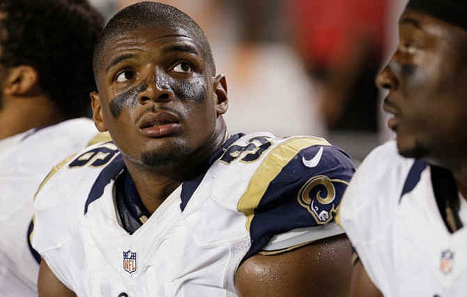 St. Louis Rams defensive end Michael Sam (96) looks up at the scoreboard from the sidelines during the first half of an NFL preseason football game against the Miami Dolphins, Thursday, Aug. 28, 2014 in Miami Gardens, Fla. The Dolphins defeated the Rams 14-13. 