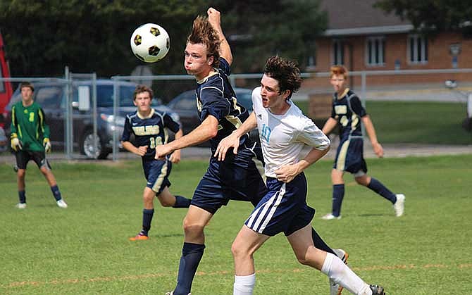 
Helias' Braden Remmert (left) heads a ball during the Crusaders' 3-1 win against Champaign (Ill.) Centennial on Saturday in the Quincy Tournament. 