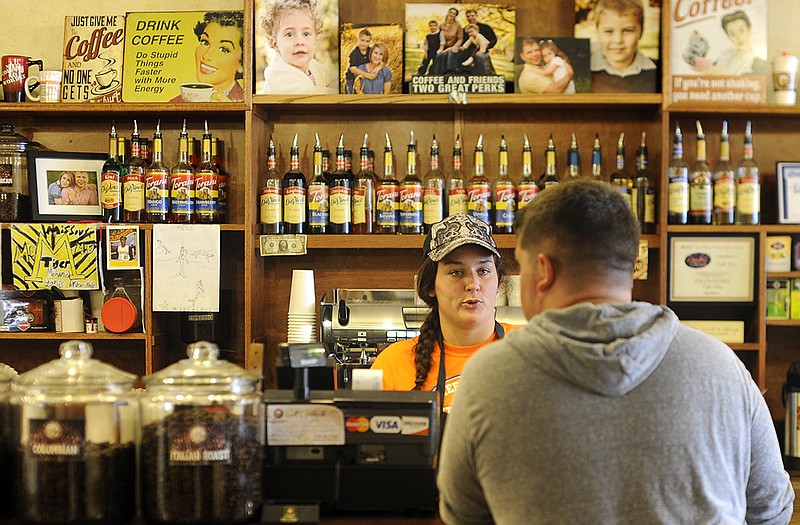 Yanis Coffee Zone barista Jordan Cheatham takes a customer's order during a holiday of steady business.