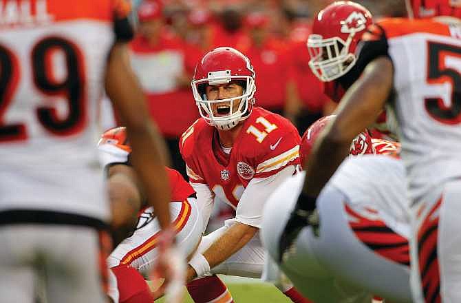 In this Aug. 7, 2014, file photo, Chiefs quarterback Alex Smith calls a play during the first half of a preseason game against the Bengals in Kansas City. Smith signed a $68-million extension Sunday to remain with the Chiefs through the 2018 season.