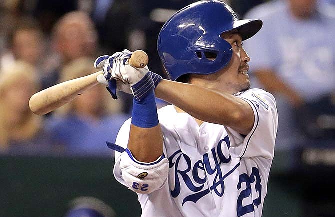 Kansas City Royals' Norichika Aoki, from Japan, hits an RBI double during the third inning of a baseball game against the Texas Rangers, Tuesday, Sept. 2, 2014, in Kansas City, Mo.