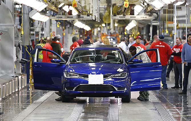 In this March 14, 2014 file photo, a 2015 Chrysler 200 automobile moves down the assembly line at the Sterling Heights Assembly Plant in Sterling Heights, Mich.