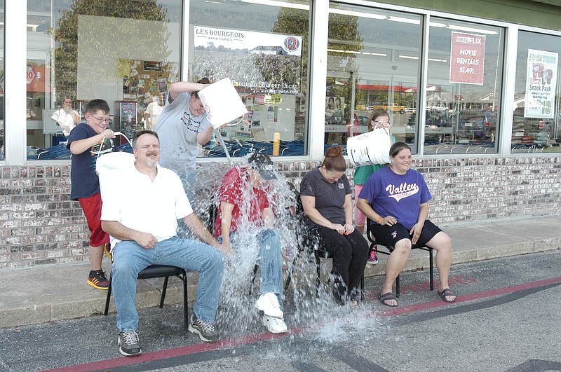 The Ice Bucket Challenge "hits" C&R employees, from left, Joe Miller, Kelly Miller, Ashley Ratliff and Sara Wetzig, Tuesday, Aug. 26, as they participate in the ALS Association fundraising event.