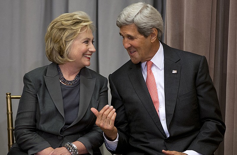 Secretary of State John Kerry speaks with former Secretary of State Hillary Rodham Clinton during the groundbreaking ceremony for the U.S. Diplomacy Center.