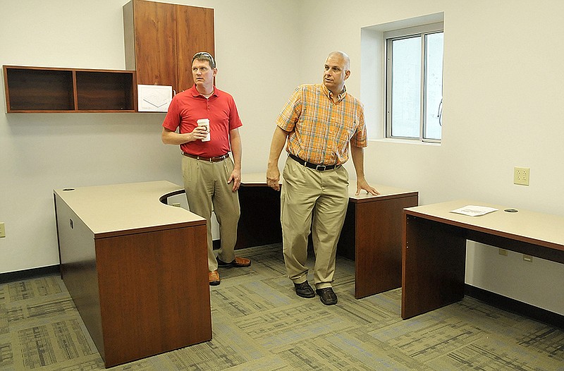 John Dickshot, right, and County Presiding Commissioner Marc Ellinger inspect the new dispatch station in the Cole County EMS building on Southridge Drive. Dickshot is project manager for R. G. Ross Construction Company in St. Louis that held the renovation contract. 