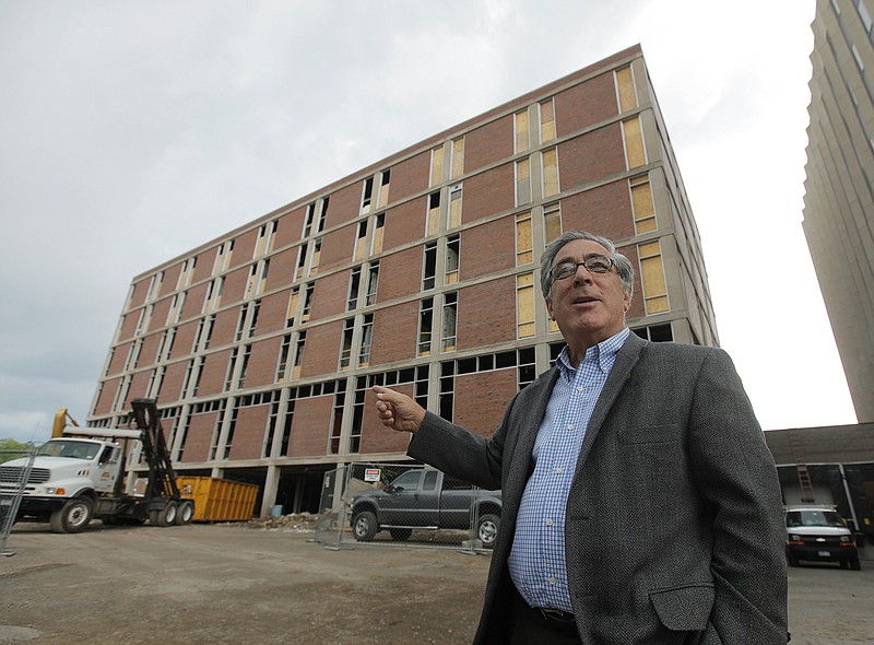 Developer Larry Glazer gestures toward a building to be demolished in June 2010 on Alexander Street in Rochester, New York. Glazer and wife, Jane, were aboard their small plane Friday, which took off from the Greater Rochester International Airport, as it flew 1,700 miles down the East Coast, before finally crashing off the coast of Jamaica.