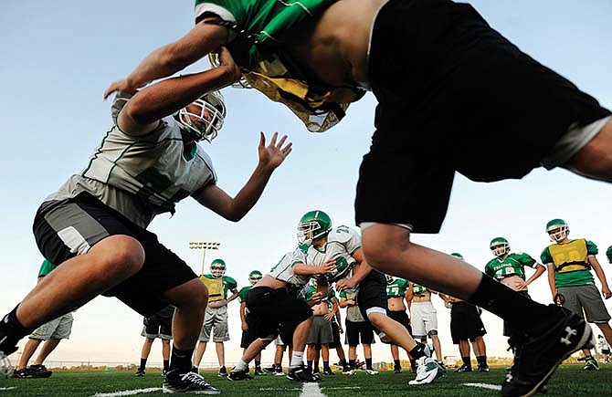 Blair Oaks defensive players call each other out and battle one-on-one during drills last month at the Falcon Athletic Complex in Wardsville, Mo.
