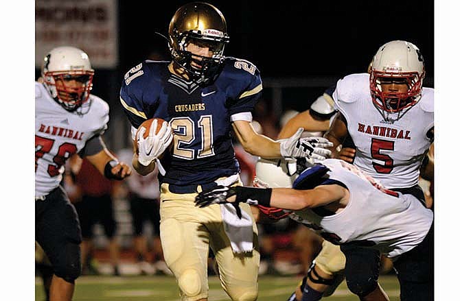 Helias running back Jacob Storms picks his way through the Hannibal defense for a big gain during last Saturday night's game against the Pirates at Adkins Stadium.