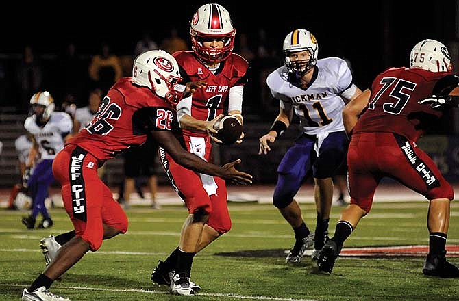 Jays quarterback Gunnar See hands the ball off to Denzel Wilson in the second quarter of Friday night's game against Hickman at Adkins Stadium. The Jays won 25-7.