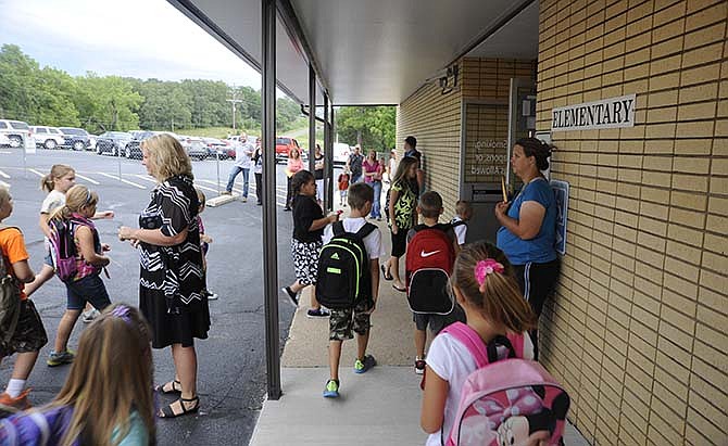 Students gather outside the elementary building during the first day of the 2014-15 school year at Cole County R-5 Schools in Eugene, Mo.