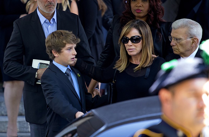 Melissa Rivers and her son Cooper Endicott walk to a waiting car after the funeral service for comedian Joan Rivers at Temple Emanu-El in New York on Sunday. Rivers died Thursday at 81.