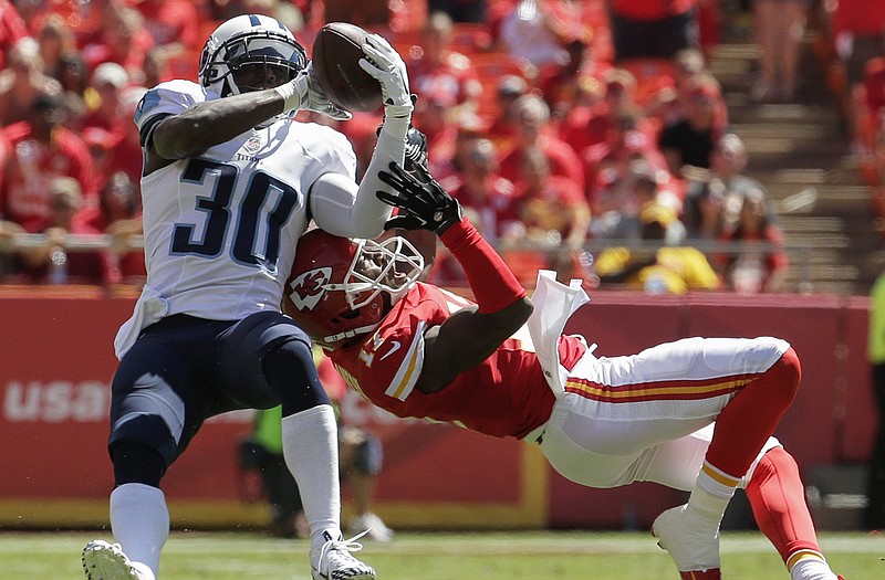 Titans cornerback Jason McCourty intercepts a pass intended for Chiefs wide receiver Donnie Avery in the first half of Sunday's game at Arrowhead Stadium.