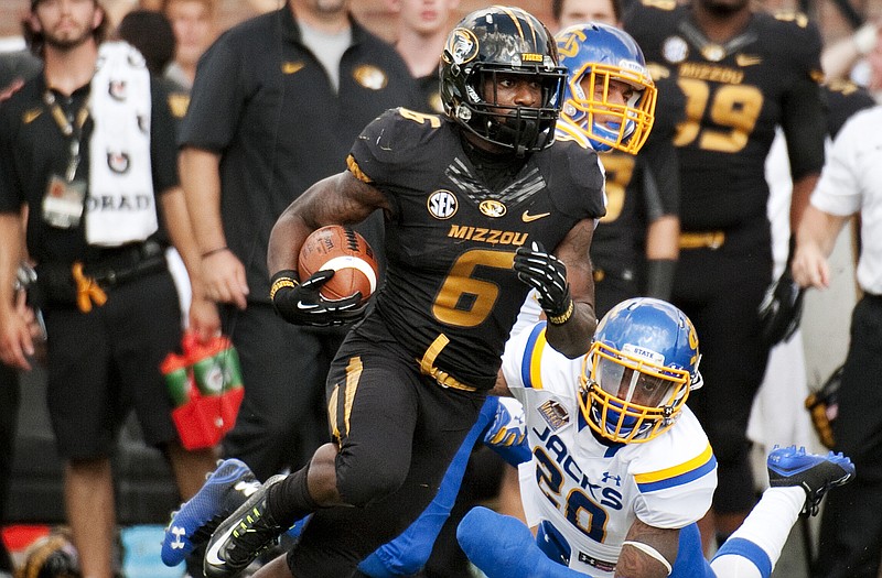 Missouri's Marcus Murphy runs past a diving South Dakota State's Freeman Simmons as he scores on a 100-yard kickoff return during a game earlier this season at Faurot Field.