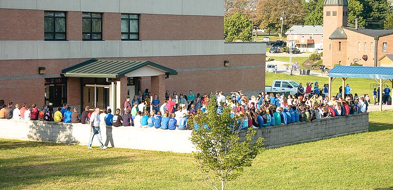 Students gather outside California Middle School waiting for power to be restored so they can begin their school day Friday, Sept. 5, 2014. The power was off for about three hours.