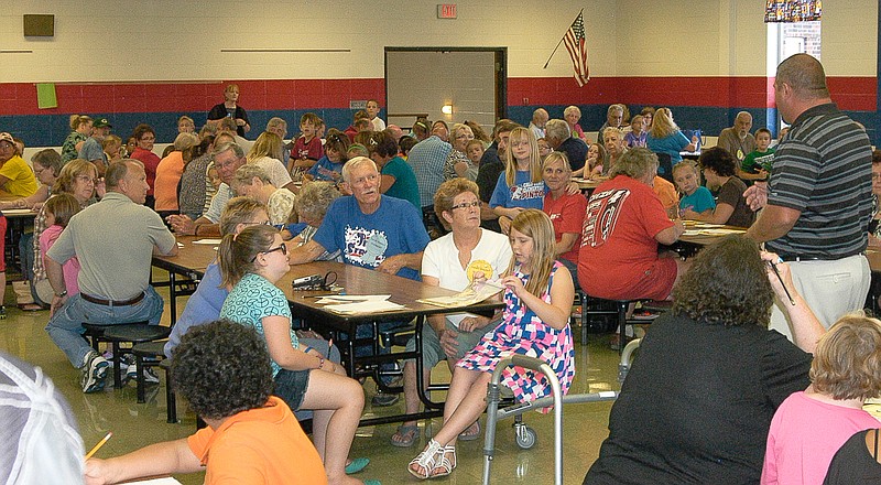 On the California Elementary third grade Grandparents Day Friday, Sept. 5, Principal Daniel Williams, right, speaks to the third graders and their families about the importance of reading with the young people and promoting literacy. The event began in the cafeteria and then moved to the individual classrooms.