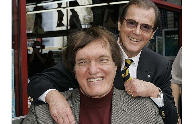 In this Oct. 11, 2007 file photo, actor Roger Moore, right, who played the part of James Bond 007 in seven films, poses with actor Richard Kiel who played the role of Jaws in "The Spy Who Loved Me," during a ceremony honoring Moore with a star on the Hollywood Walk of Fame, in the Hollywood section of Los Angeles. Kiel, the 7-foot-2-inch performer famously played the cable-chomping henchman who tussled with Moore's Bond in "The Spy Who Loved Me" and "Moonraker" has died. He was 74.