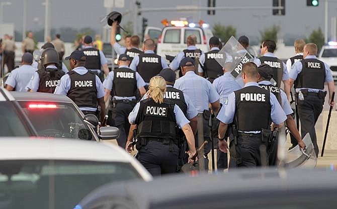 St. Louis city police stand down after an attempt to shut down interstate 70 was stifled, Wednesday, Sept. 10, 2014 in Berkeley, Mo. near the St. Louis suburb of Ferguson, Mo. where Michael Brown, an unarmed, black 18-year old was shot and killed by a white police officer on Aug. 9. 
