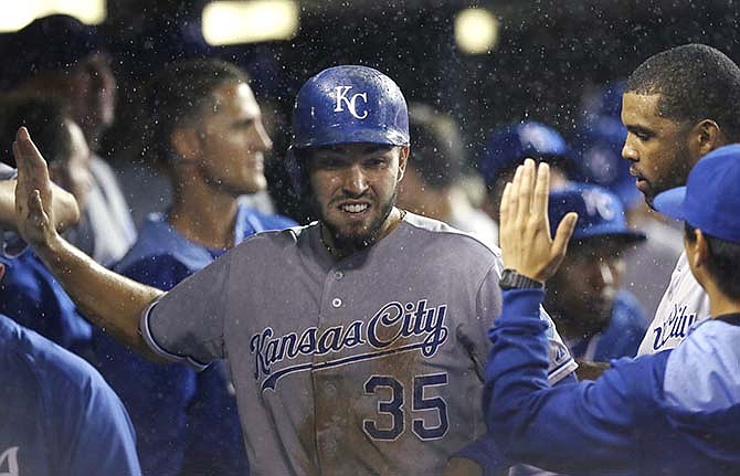 Kansas City Royals' Eric Hosmer is greeted in the dugout after scoring from third on a single by teammate Lorenzo Cain during the fourth inning of a baseball game against the Detroit Tigers in Detroit, Wednesday, Sept. 10, 2014.