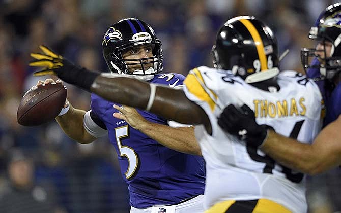 Baltimore Ravens quarterback Joe Flacco (5) looks to pass under pressure from Pittsburgh Steelers nose tackle Cam Thomas (96) during the first half of an NFL football game Thursday, Sept. 11, 2014, in Baltimore.