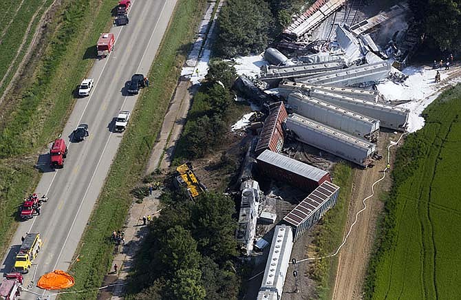 In Sunday, Aug. 17, 2014 file photo, emergency personnel work at the site of a head-on collision of two Union Pacific trains outside of Hoxie, Ark. Arkansas emergency officials' records show that as many as 33 trains carrying Bakken crude oil pass through the state in a given week. (AP Photo/Arkansas Democrat-Gazette, Melissa Sue Gerrits, File)