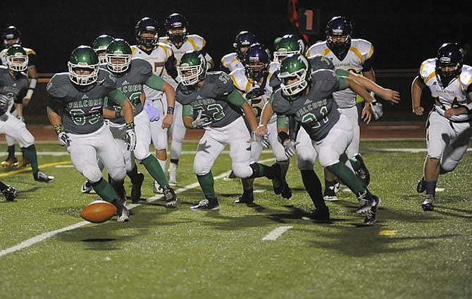 Blair Oaks players chase down a fumble that would set up Falcons' only first half touchdown in Friday's game.