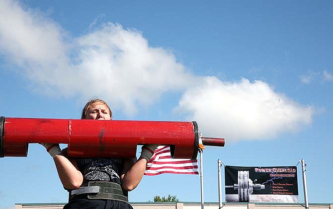 Mendison Vance lifts 100 pounds weight during the Strong Man Contest on Saturday in Holts Summit, Mo. "It scares me but it's a rush," Vance said. "I'm feeling good when I'm done."