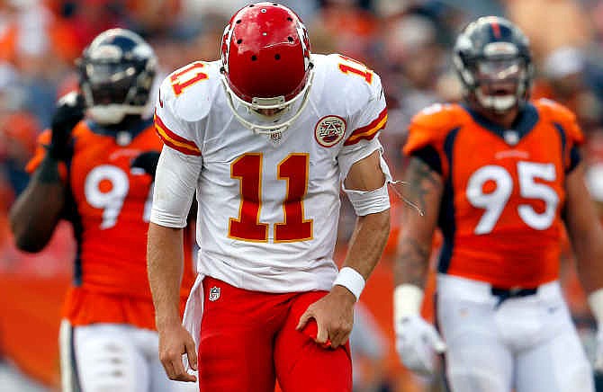 Kansas City Chiefs quarterback Alex Smith (11) looks down after an incomplete pass against the Denver Broncos during the second half of an NFL football game, Sunday, Sept. 14, 2014, in Denver. (